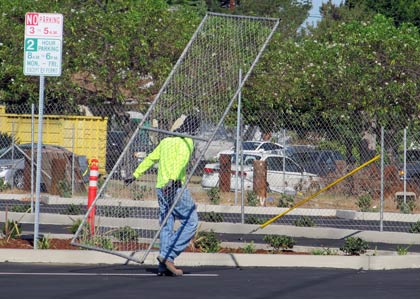 Photo: FLLewis / Media City G -- Worker removed the fence surrounding the new parking lot on Magnolia Boulevard between Kenwood and Maple Streets in Burbank September 13, 2014