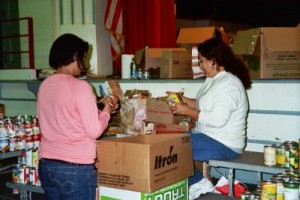 Photo: FLLewis/Media City G --Two volunteers sort through donated items for the Holiday Basket Program at George Washington Elementary in Burbank December 17, 2010