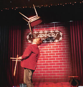 Photo: FLLewis/Media City G -- Comedian Michael Rayner performs a stunt at Flappers Comedy Club in Burbank, November 9, 2010 