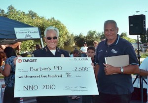 Photo: FLLewis/Media City G -- Burbank Police Chief Scott LaChasse and Burbank Police Commissioner Jim Etter show off a $2,500 donation from Target to the BPD, at the NNO Chandler Boulevard block party , August 3, 2010