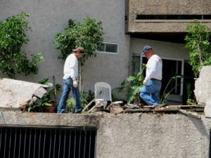 Photo: FLLewis/Media City G -- Workmen survey the damage to an apartment balcony caused by a toppled tree on Bethany Road in Burbank March 22, 2011