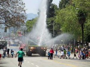 Photo: FLLewis/Media City G -- Spectators, mostly children, ran into the street to get splashed with water by the Bob  Hope Airport fire truck during Burbank on Parade April 6, 2013