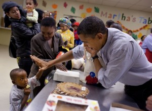 Photo: Pete Souza/White House -- President Obama gives a high-five to a little boy during a food giveaway in Washington DC, November 24, 2010