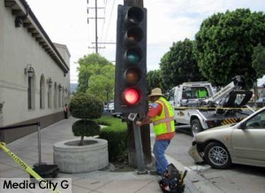 Photo: FLLewis/ Media City G --Burbank Public Works technician inspected damaged traffic signal in front of Porto's in Burbank July 28, 2014