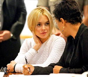 Photo: Mario Anzuoni/Pool/Los Angeles Times -- Lindsay Lohan talks with her attorney Shawn Chapman Holley during an arraignment on a felony grand theft charge in Los Angeles February 9, 2011