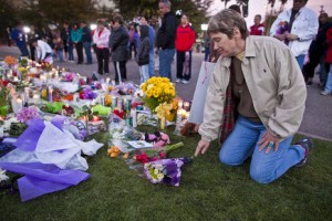 Photo: Jack Kurtz/Arizona Republic -- Nancy Platt adds a bouquet of flowers to a makeshift memorial outside University Medical Center in Tucson, Arizona January 9, 2011