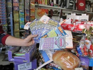 Photo: FLLewis/Media City G -- Tom Huber, owner Otto's Import Store & Delicatessen, showed off some of the scratcher games, which have produced winners at his store December 17, 2013 