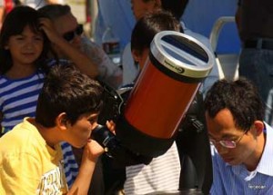 Photo: Terje "Terry" Canavarro/Freelance Photog -- A young skywatcher gazed through a telescope at Griffith Park Observatory hoping to see the rare annular solar eclipse May 20, 2012
